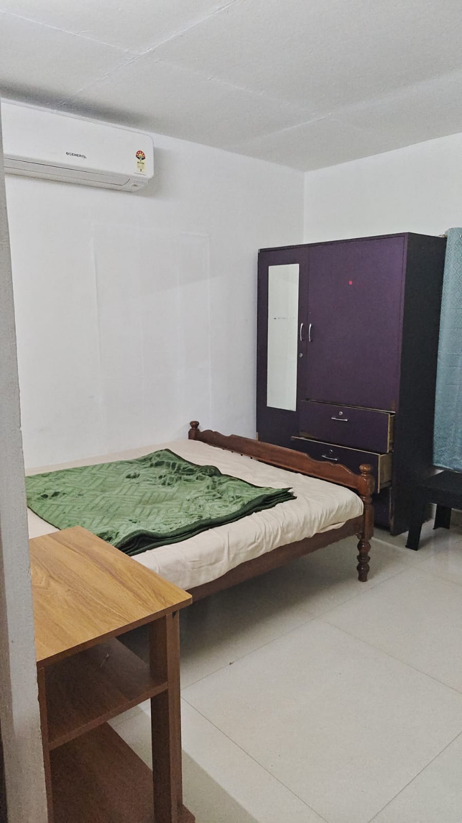 Inside a Dharshana bedroom with a wardrobe and single bed