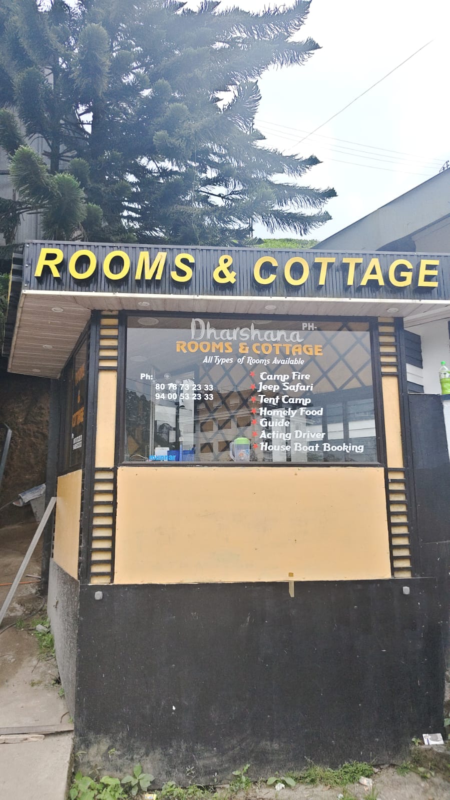 Dharshana Rooms and Cottage signboard outside the stay