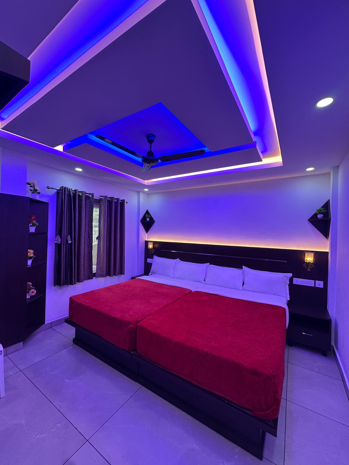 Inside the G Mount Luxury deluxe family room with two beds and colour ceiling lights