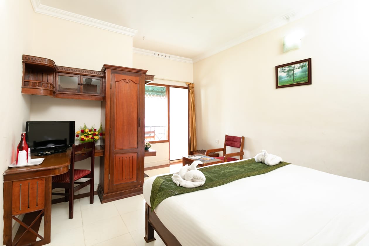 Inside a Le Celestium deluxe room with wooden furniture