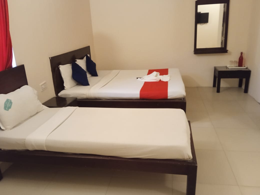 Inside the Lumino Karthika family room with a double bed and a single bed